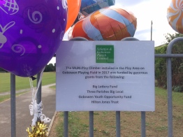 Balloons and a sign listing the organisations that had funded a piece of play equipment at Gobowen Playing Field.